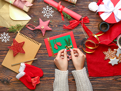 Image of someone making Christmas cards. Link to Do Good, Feel Good – Christmas workshops.