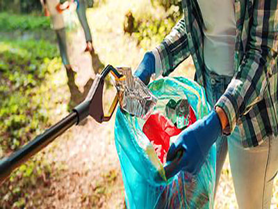 A person holding a blue bag of litter, with a litter picker placing rubbish into the bag. . Link to Do Good, Feel Good & keep Boro tidy! Thursday 24 April .