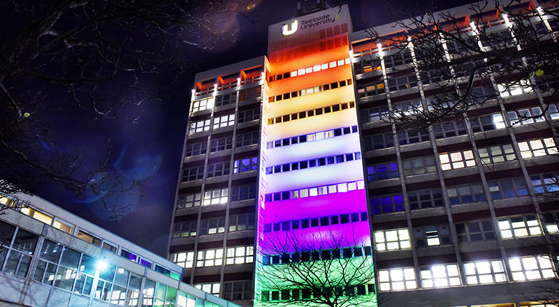 The Tower building lit up in rainbow colours to celebrate Pride month