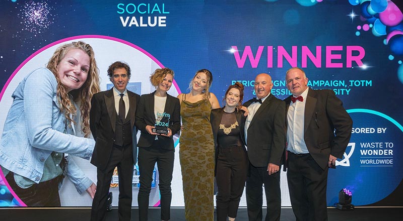 Actor Stephen Mangan, who hosted the IWFM Impact Awards event, pictured with Vik Brown holding the award, and representatives from TOTM and IWFM 