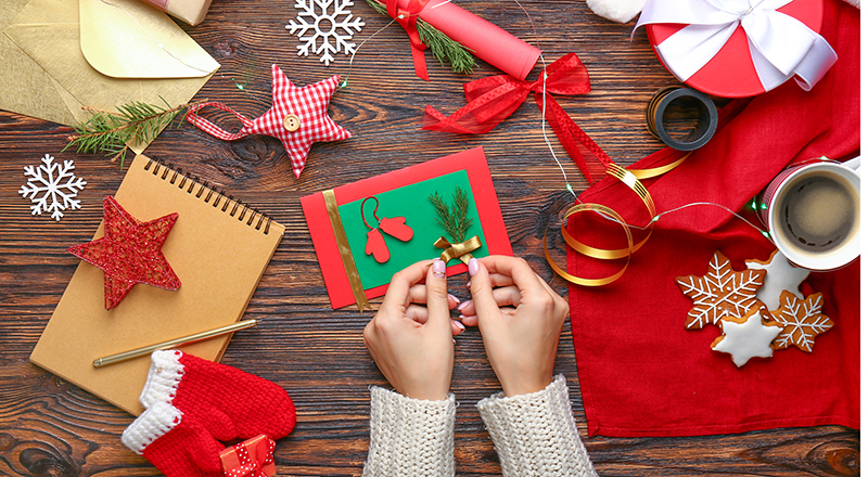 Image of someone making Christmas cards