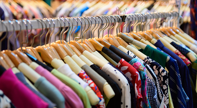 Variety of clothing items hanging on a  clothing rail