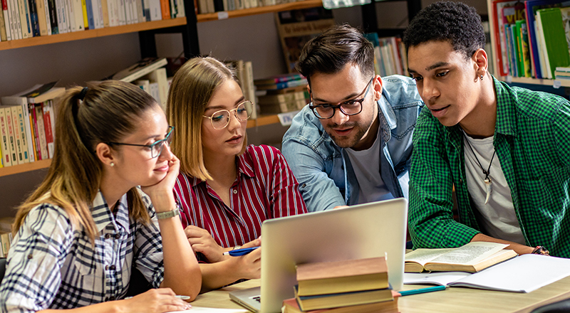 Group of students working together at a laptop