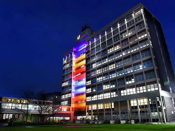 Middlesbrough Tower illuminated in vibrant hues of blue, yellow, red, white, and orange, in honour of Wesak