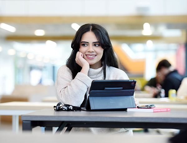 Student with a tablet in Student life building