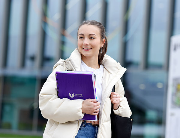 Student walking through the campus center