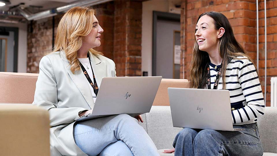 Students on campus with laptops